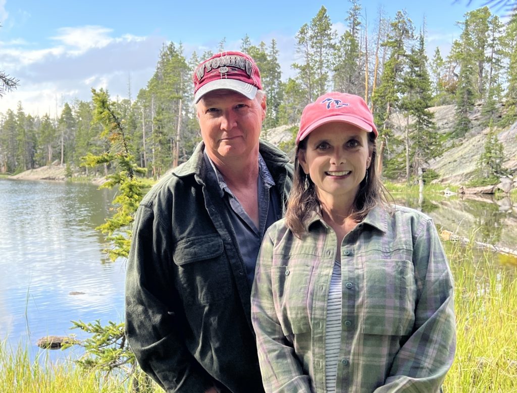 Elgin and Melissa Cook standing by a lake